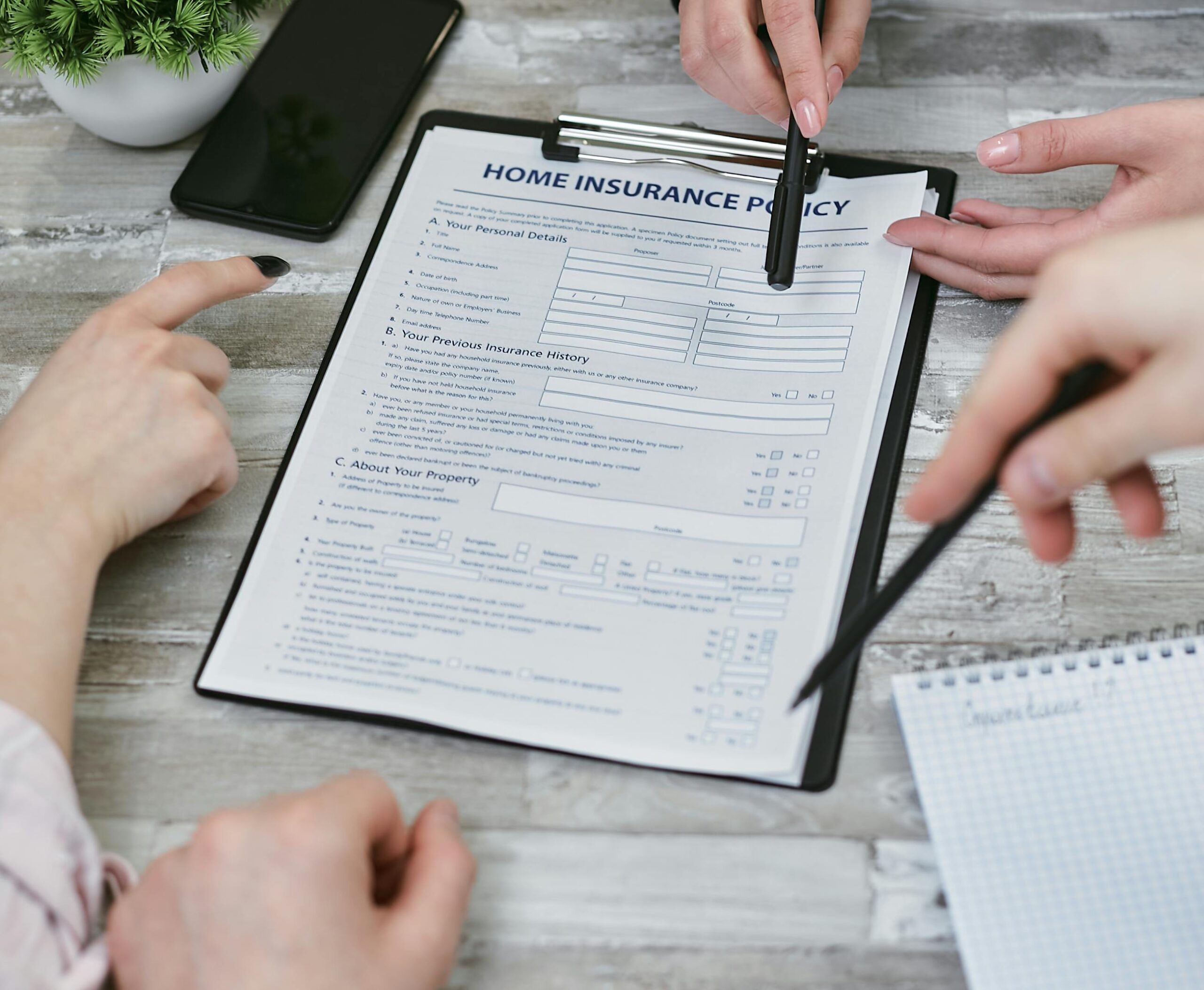 homeowner reviewing homeowners insurance policy with insurance agent